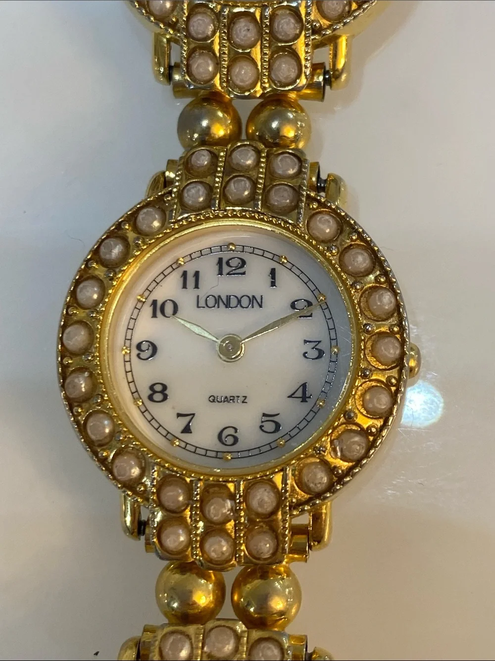 Faux pearl gold tone watch